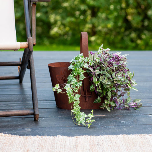 Rustic Metal Planter with Handle, Cut-Out Floral Design, Natural Rust Finish